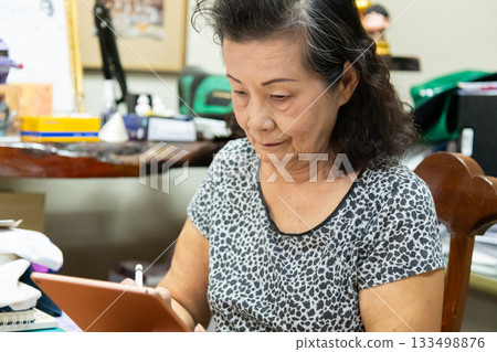 Grandma works at home 133498876
