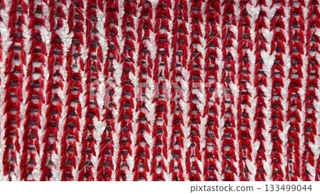 Abstract macro background of red and white knitted fabric with a distinct zigzag/wavy texture Abstract macro background of red and white knitted fabric with a distinct zigzag/wavy texture 133499044