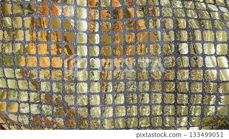 Gold and silver sequin fabric macro background. Shimmering mosaic pattern for luxury party and fashion design Gold and silver sequin fabric macro background. Shimmering mosaic pattern for luxury party and fashion design 133499051