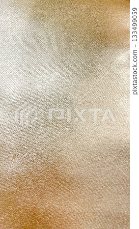 Soft beige-gold velvet fabric texture background. Luxurious abstract material with subtle sheen and light Soft beige-gold velvet fabric texture background. Luxurious abstract material with subtle sheen and light 133499059