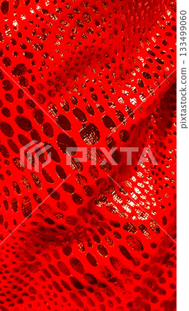 Vibrant red abstract fabric with intricate hole pattern and dynamic flowing texture, modern macro backdrop Vibrant red abstract fabric with intricate hole pattern and dynamic flowing texture, modern macro backdrop 133499060
