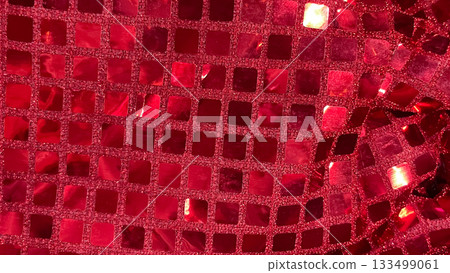 Vibrant red sequin fabric macro background. Square glitter texture for party, fashion, and celebration designs Vibrant red sequin fabric macro background. Square glitter texture for party, fashion, and celebration designs 133499061