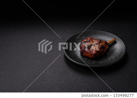Steak, beef or pork on the bone, meat cooked on the grill with rosemary. Steak on the bone 133499277