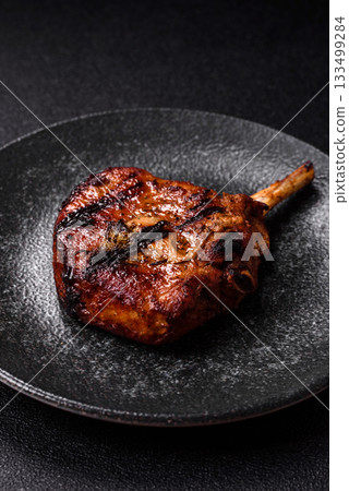 Steak, beef or pork on the bone, meat cooked on the grill with rosemary. Steak on the bone Steak, beef or pork on the bone, meat cooked on the grill with rosemary. Steak on the bone 133499284
