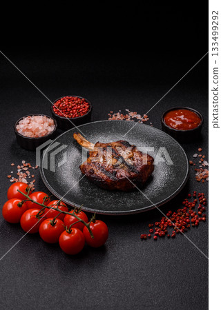 Steak, beef or pork on the bone, meat cooked on the grill with rosemary. Steak on the bone Steak, beef or pork on the bone, meat cooked on the grill with rosemary. Steak on the bone 133499292