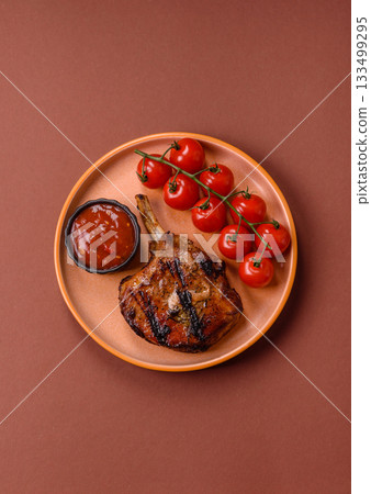 Steak, beef or pork on the bone, meat cooked on the grill with rosemary. Steak on the bone Steak, beef or pork on the bone, meat cooked on the grill with rosemary. Steak on the bone 133499295