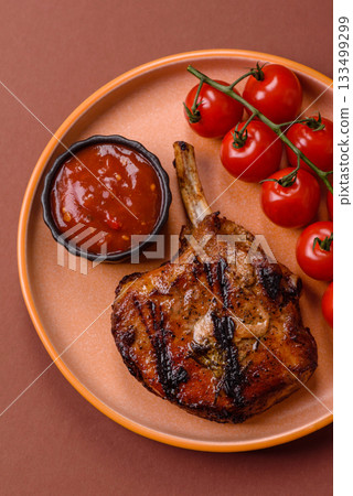 Steak, beef or pork on the bone, meat cooked on the grill with rosemary. Steak on the bone Steak, beef or pork on the bone, meat cooked on the grill with rosemary. Steak on the bone 133499299