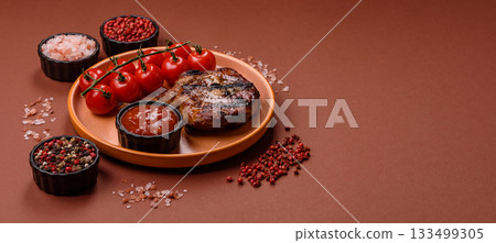 Steak, beef or pork on the bone, meat cooked on the grill with rosemary. Steak on the bone Steak, beef or pork on the bone, meat cooked on the grill with rosemary. Steak on the bone 133499305