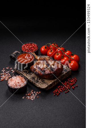 Steak, beef or pork on the bone, meat cooked on the grill with rosemary. Steak on the bone Steak, beef or pork on the bone, meat cooked on the grill with rosemary. Steak on the bone 133499324