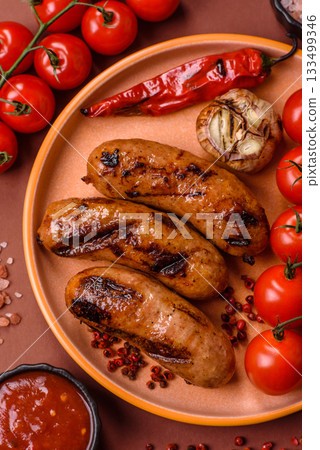 Grilled chicken or beef sausages with sauce and spices. Grilled sausages 133499346