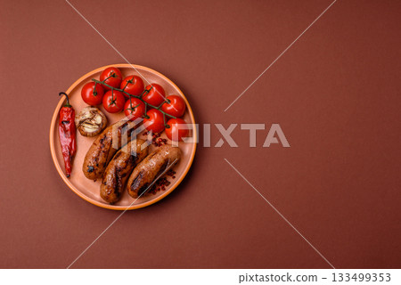 Grilled chicken or beef sausages with sauce and spices. Grilled sausages 133499353