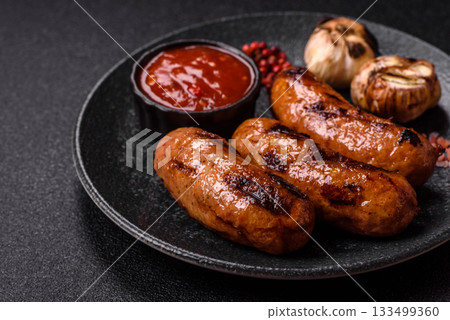Grilled chicken or beef sausages with sauce and spices. Grilled sausages 133499360