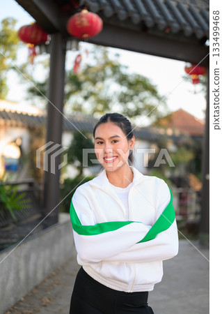 Young Asian Woman in Sporty Casual Outfit Outdoors With Arms Crossed Young Asian Woman in Sporty Casual Outfit Outdoors With Arms Crossed 133499468