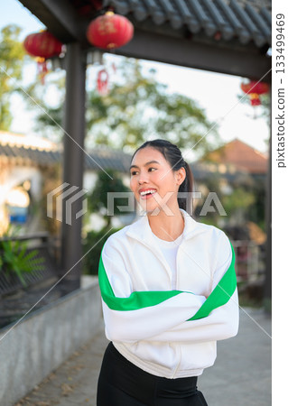 Young Asian Woman in Sporty Casual Outfit Outdoors With Arms Crossed Young Asian Woman in Sporty Casual Outfit Outdoors With Arms Crossed 133499469