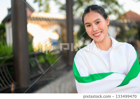 Young Asian Woman in Sporty Casual Outfit Outdoors With Arms Crossed 133499470