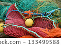 Multicolored green red fishing nets in the port 133499588