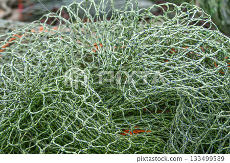 The green fishing nets on the beach 133499589