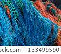 Multicolored orange blue fishing nets in the port 133499590