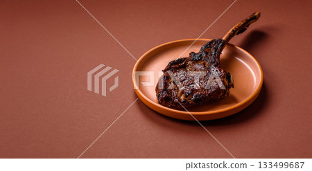 Grilled bone-in meat, beef tomahawk steak, juicy barbecued meat. Tomahawk steak 133499687