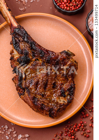 Grilled bone-in meat, beef tomahawk steak, juicy barbecued meat. Tomahawk steak 133499714