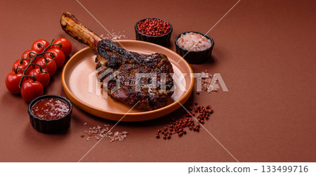 Grilled bone-in meat, beef tomahawk steak, juicy barbecued meat. Tomahawk steak Grilled bone-in meat, beef tomahawk steak, juicy barbecued meat. Tomahawk steak 133499716