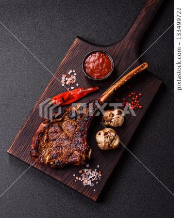 Grilled bone-in meat, beef tomahawk steak, juicy barbecued meat. Tomahawk steak 133499722