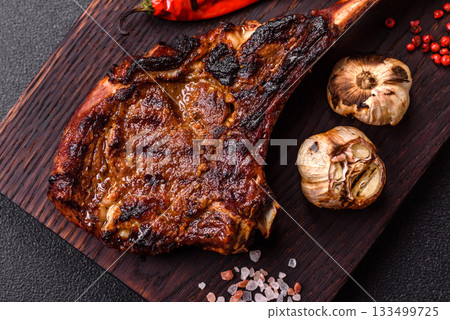 Grilled bone-in meat, beef tomahawk steak, juicy barbecued meat. Tomahawk steak 133499725