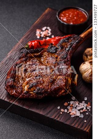 Grilled bone-in meat, beef tomahawk steak, juicy barbecued meat. Tomahawk steak 133499727