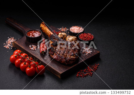 Grilled bone-in meat, beef tomahawk steak, juicy barbecued meat. Tomahawk steak 133499732