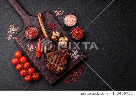 Grilled bone-in meat, beef tomahawk steak, juicy barbecued meat. Tomahawk steak Grilled bone-in meat, beef tomahawk steak, juicy barbecued meat. Tomahawk steak 133499733