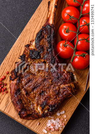 Grilled bone-in meat, beef tomahawk steak, juicy barbecued meat. Tomahawk steak 133499741