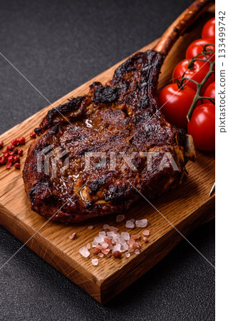 Grilled bone-in meat, beef tomahawk steak, juicy barbecued meat. Tomahawk steak 133499742