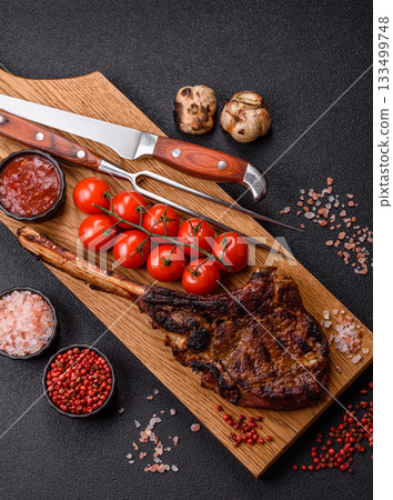 Grilled bone-in meat, beef tomahawk steak, juicy barbecued meat. Tomahawk steak Grilled bone-in meat, beef tomahawk steak, juicy barbecued meat. Tomahawk steak 133499748