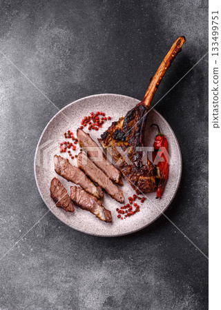 Grilled bone-in meat, beef tomahawk steak, juicy barbecued meat. Tomahawk steak 133499751