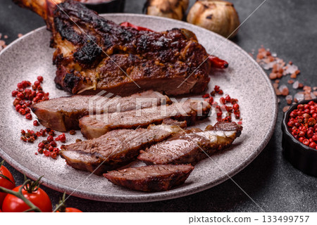 Grilled bone-in meat, beef tomahawk steak, juicy barbecued meat. Tomahawk steak Grilled bone-in meat, beef tomahawk steak, juicy barbecued meat. Tomahawk steak 133499757
