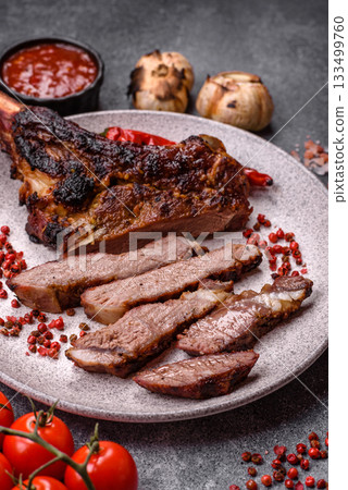 Grilled bone-in meat, beef tomahawk steak, juicy barbecued meat. Tomahawk steak 133499760