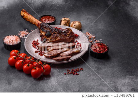 Grilled bone-in meat, beef tomahawk steak, juicy barbecued meat. Tomahawk steak Grilled bone-in meat, beef tomahawk steak, juicy barbecued meat. Tomahawk steak 133499761