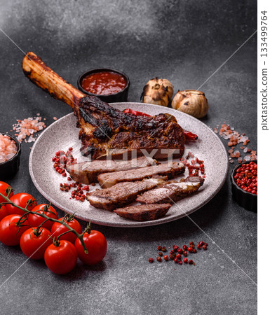 Grilled bone-in meat, beef tomahawk steak, juicy barbecued meat. Tomahawk steak Grilled bone-in meat, beef tomahawk steak, juicy barbecued meat. Tomahawk steak 133499764