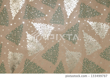 Kraft background with green and gold Christmas trees and snowflakes 133499787