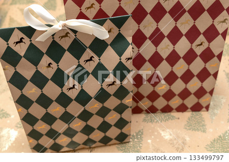 Red and green Christmas gift bags with bows 133499797