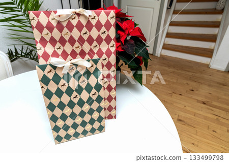 Christmas gift boxes with red poinsettia flower. Christmas gift boxes with red poinsettia flower. 133499798