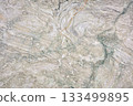 Intricate swirls and patterns of natural stone create a unique textured surface 133499895