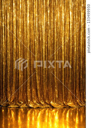 A shimmering gold curtain backdrop suitable for Christmas and New Year celebration. Glossy reflective golden festive vertical background 133499930
