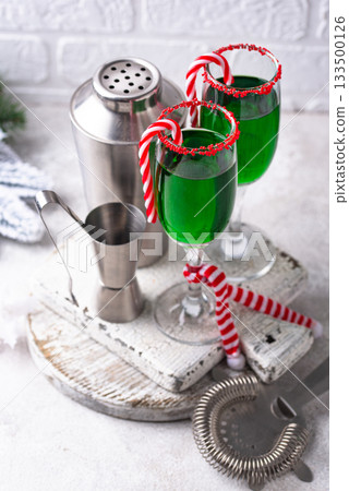 Christmas green cocktail punch with candy cane Christmas green cocktail punch with candy cane 133500126