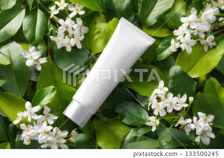Blank white cosmetic tube mockup green leaves background, ai generated 133500245