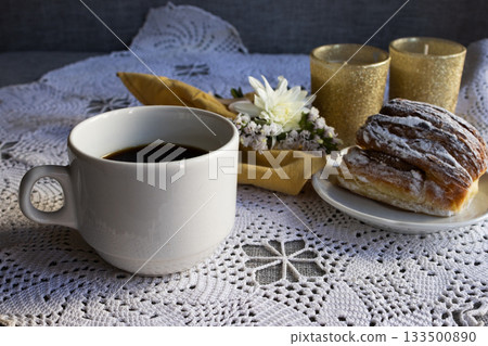 Side view of a set with coffe and pastry served on a white tablecloth with white flowers and candles. Ideal for Valentine's Day, Mother's Day. Copy space 133500890