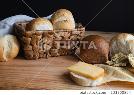 Appetizing scene displaying fresh bread, savory cheese, and crispy crackers on a cutting board, Appetizing scene displaying fresh bread, savory cheese, and crispy crackers on a cutting board, 133500894