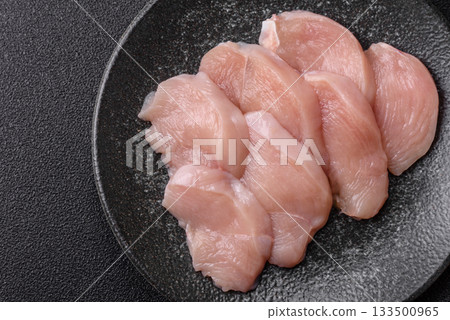 Slices of raw chicken or turkey breast, skinless and boneless. Chicken breast slices Slices of raw chicken or turkey breast, skinless and boneless. Chicken breast slices 133500965