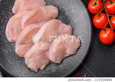 Slices of raw chicken or turkey breast, skinless and boneless. Chicken breast slices Slices of raw chicken or turkey breast, skinless and boneless. Chicken breast slices 133500968
