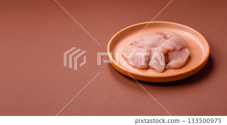 Slices of raw chicken or turkey breast, skinless and boneless. Chicken breast slices 133500975